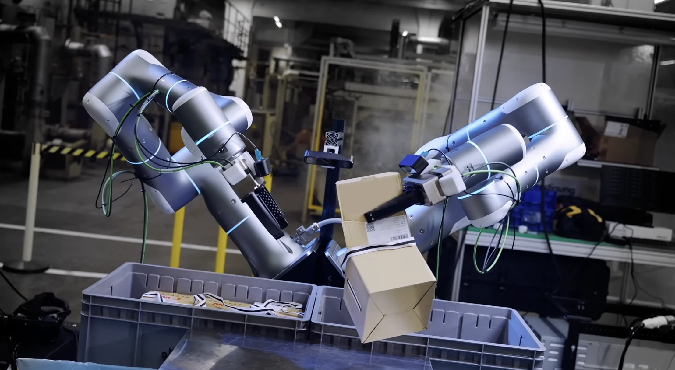 Robot decanting boxes in an industrial workspace